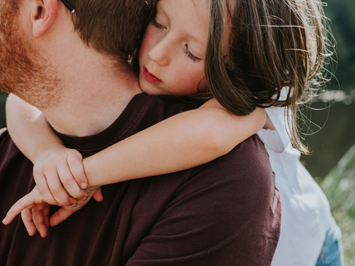 Father carrying young daughter on his back.jpg